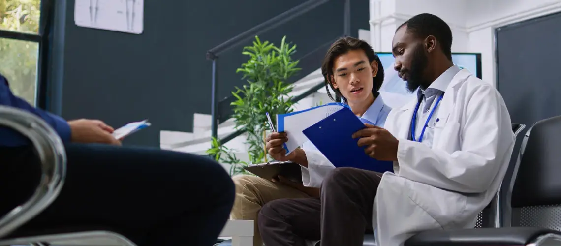 A doctor discussing medical plant-based therapy treatment options with a patient