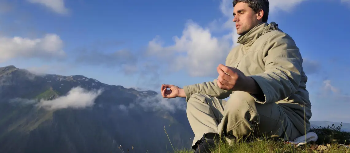 A calm person meditating next to medical weed products